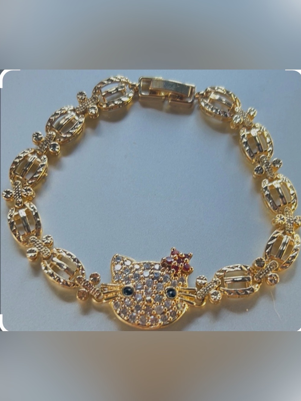Gold-Tone Hello Kitty Bracelet with Red Accent and Crystal Detailing